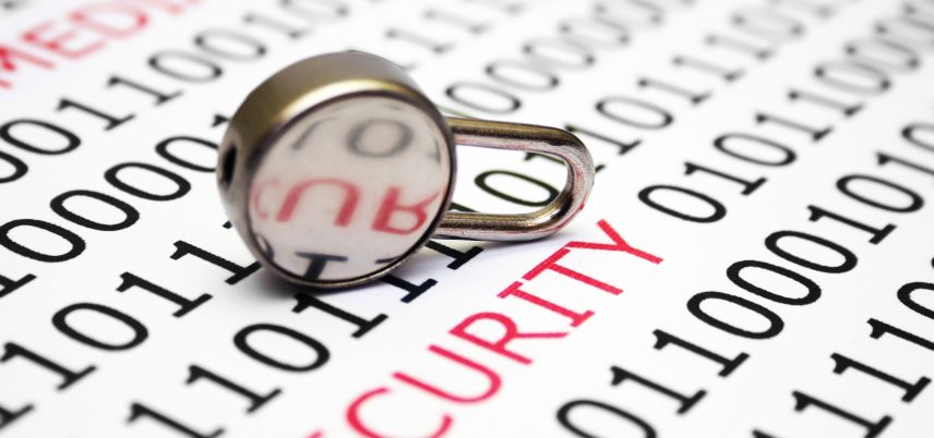 small padlock sitting on binary code