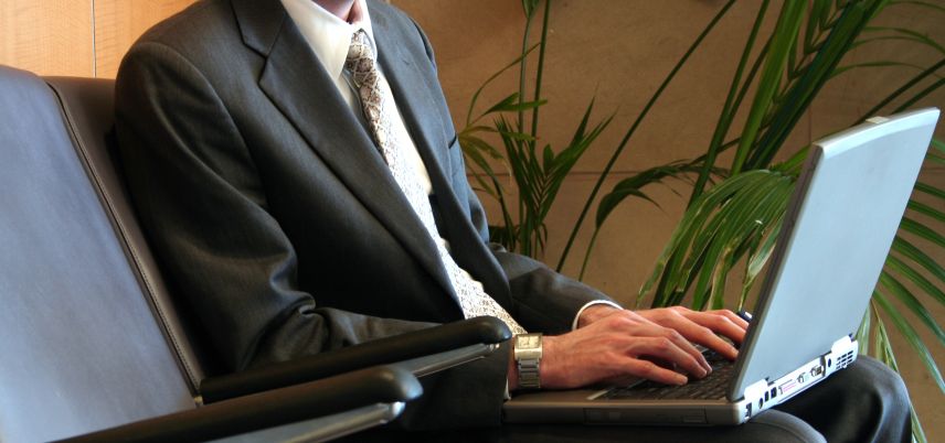 man in suit working on laptop