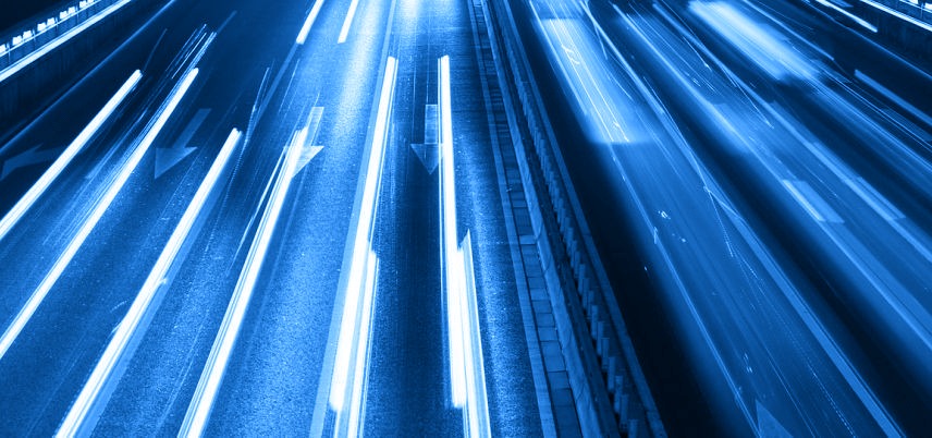 overhead shot of highway, blurred headlights, blue tint