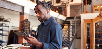 AdobeStock_353594523 Man using tablet in retail setting
