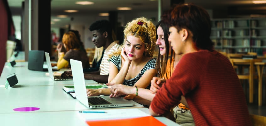 group of people looking at laptop