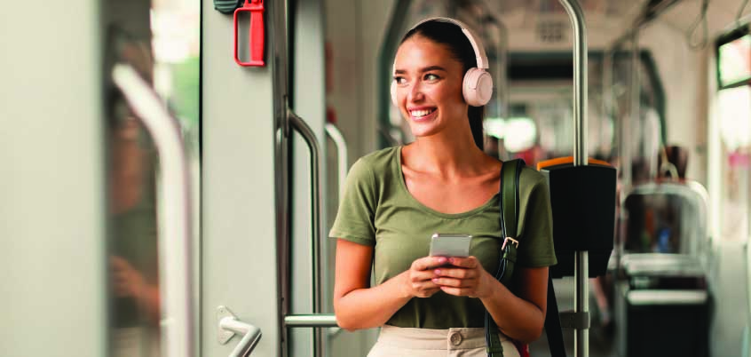 Woman with headphones on subway