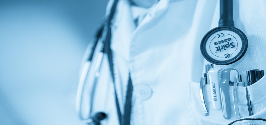 stethoscope and pocket full of pens close up, blue tint