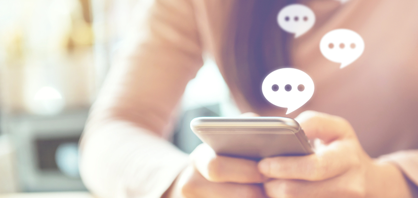 Photo of person on phone with text icons.