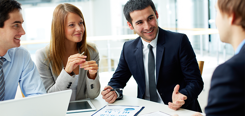 Team discussing charts on paper