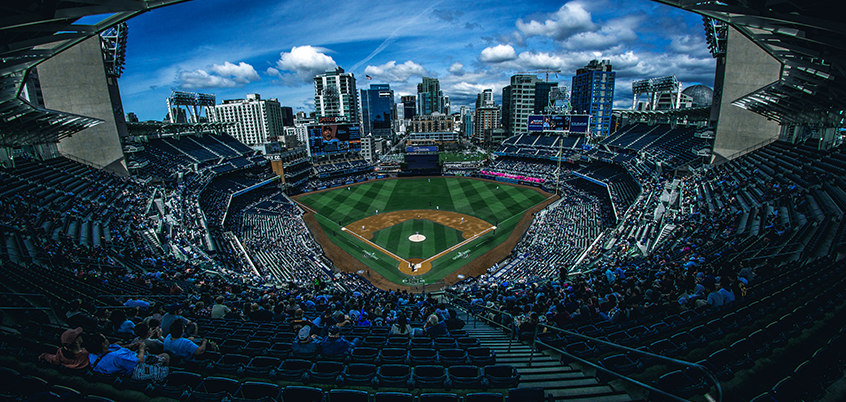 Baseball stadium with city skyline.