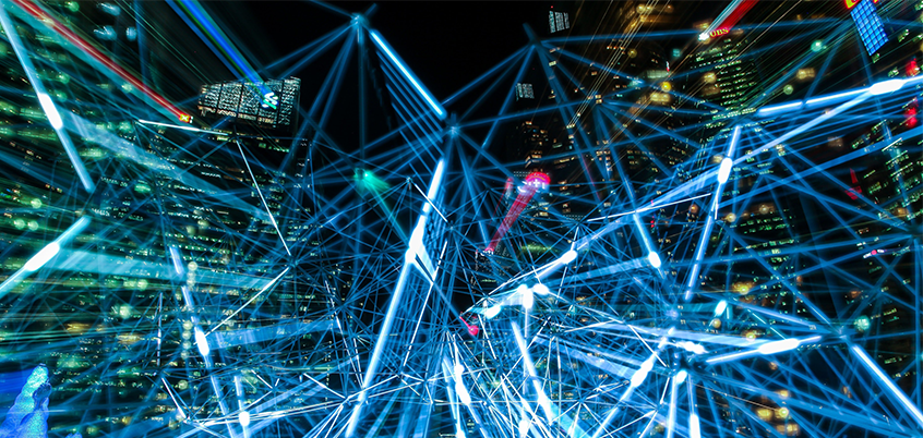 blue digital network graphic over cityscape