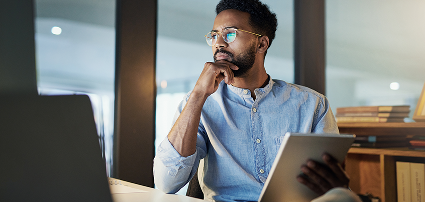 man on ipad thinking