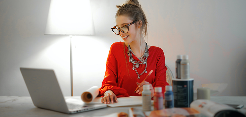 Woman working from home on laptop.