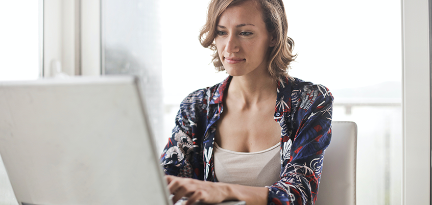 Woman working on laptop at home.