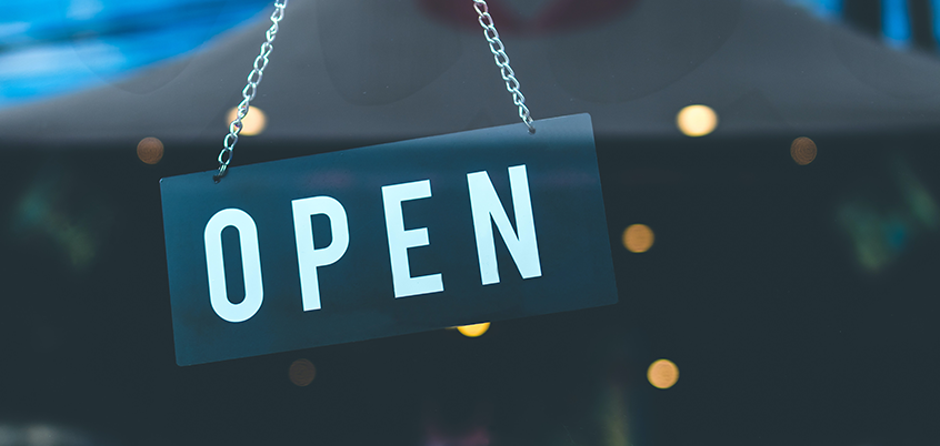 Photo of open sign on shop door.