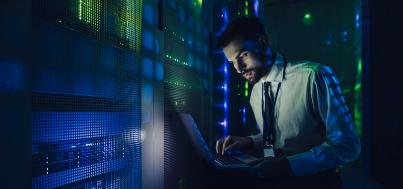 Man on laptop with server