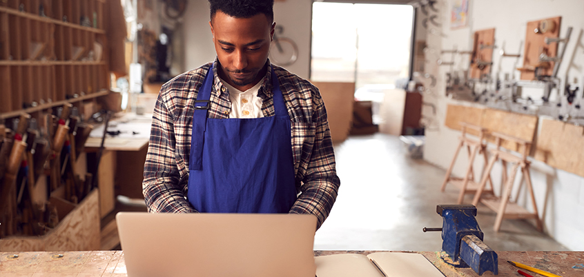 Man in workshop on laptop