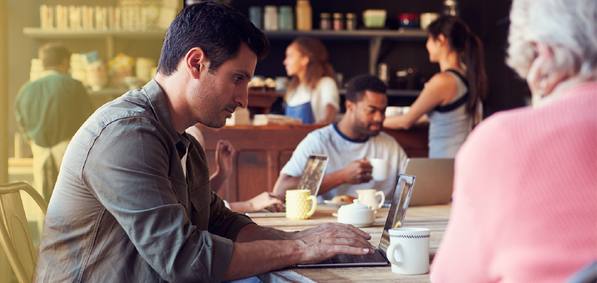 Man sitting in cafe on laptop