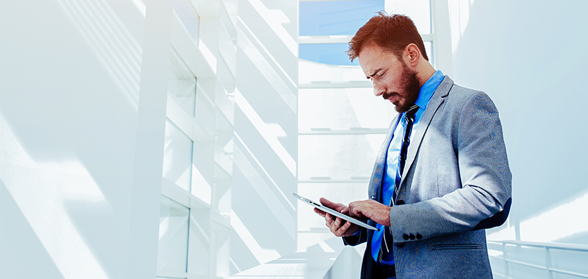 man on ipad in suit