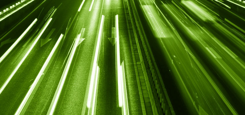 overhead shot of highway, blurred headlights, green tint