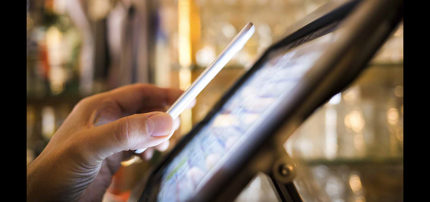 hand holding tablet over touchscreen