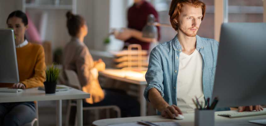 Man sitting in front of desktop computer