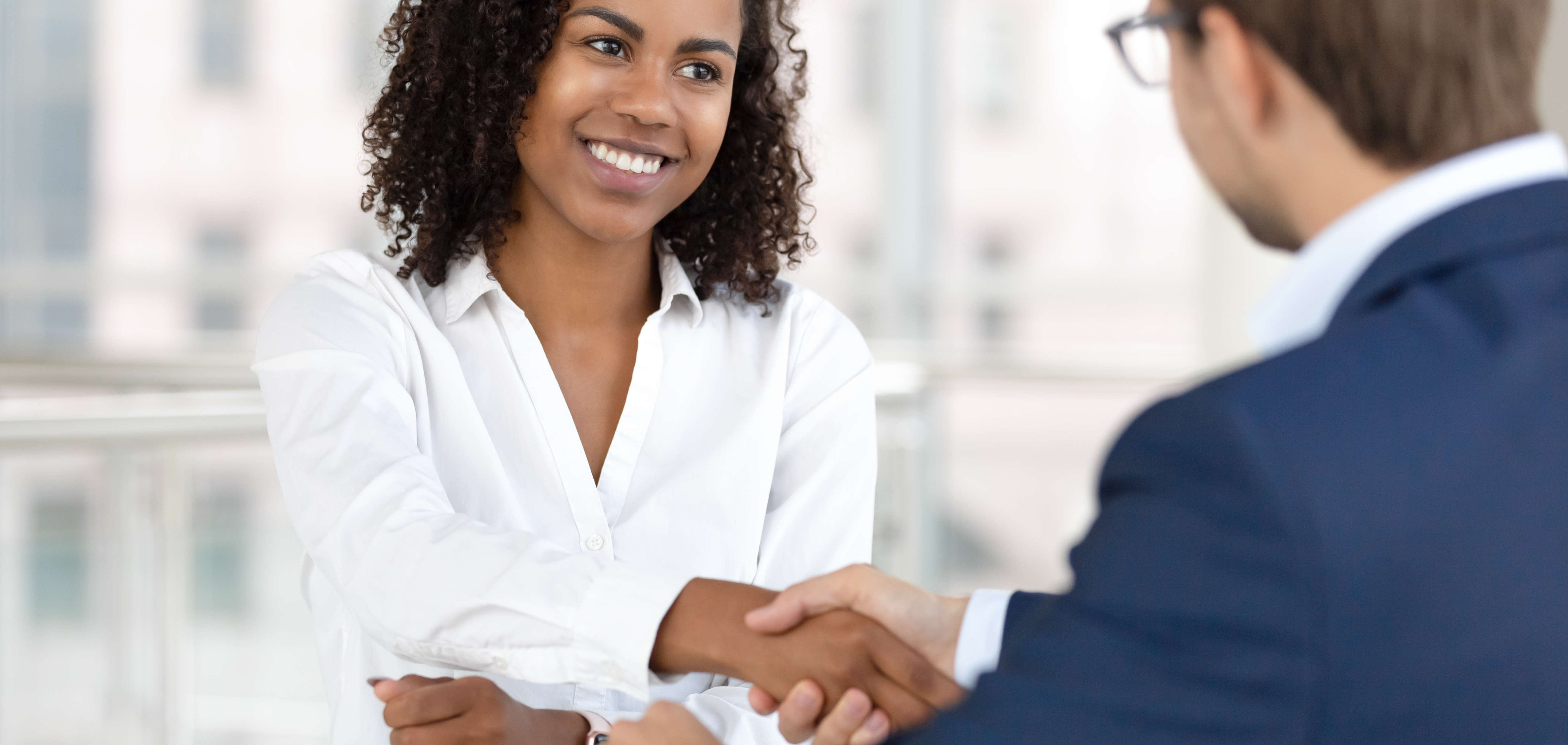 Woman shaking hands with man