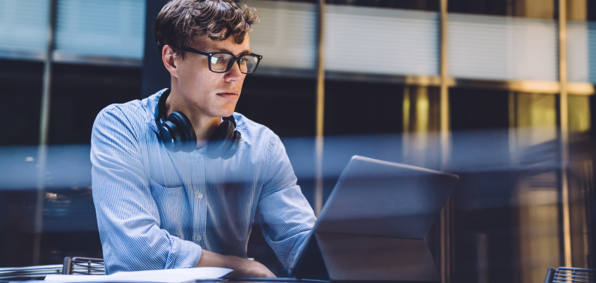 Man with Headphones On Ipad