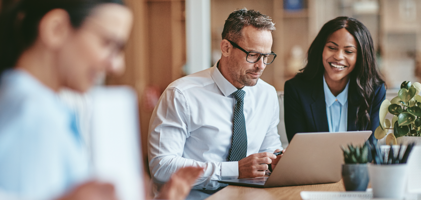 Man And Woman Looking At Laptop