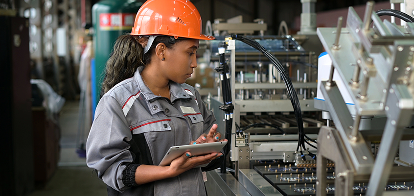 Woman in hard hat on ipad