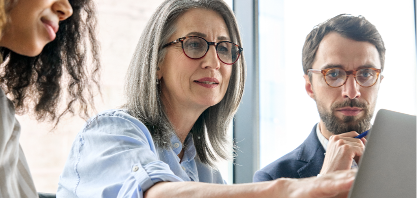 Closeup of people looking at laptop