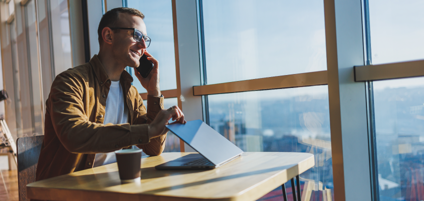 Man Looking Out Window On Phone