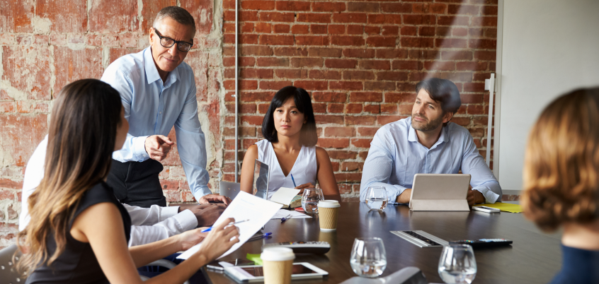 Group of people having a meeting around a table