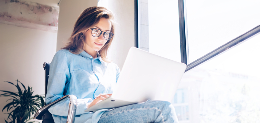 Woman working on laptop.