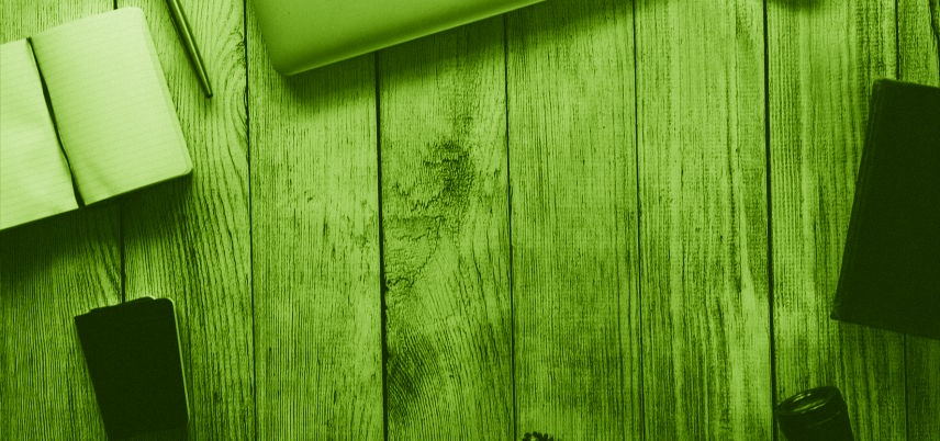 overhead shot of notebook and devices, green tint