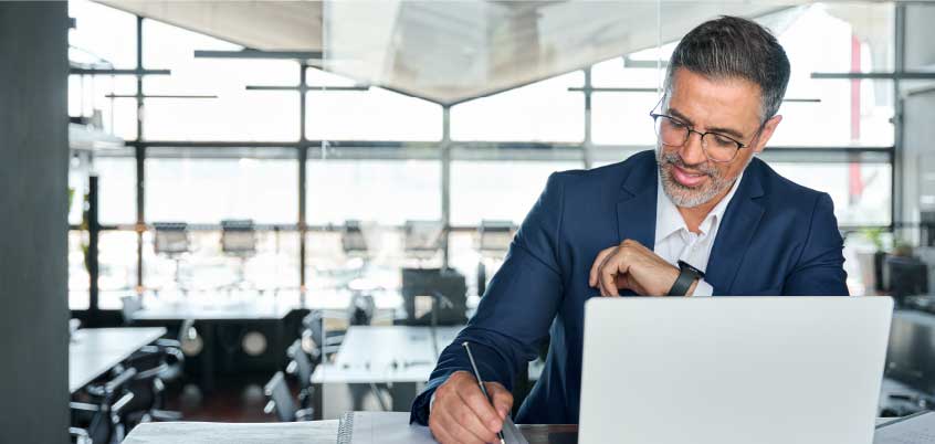 Man in suit working on laptop