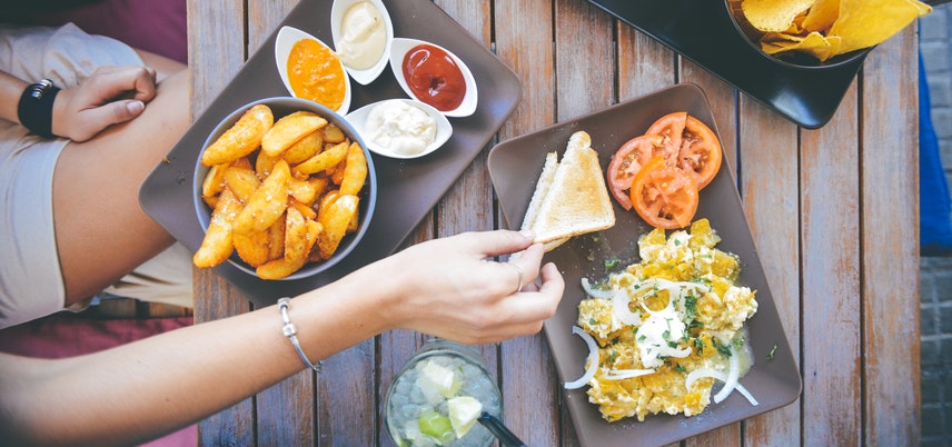 Hand reaching for nachos