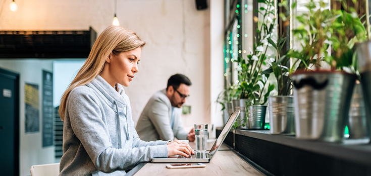 Woman sitting at counter with laptop