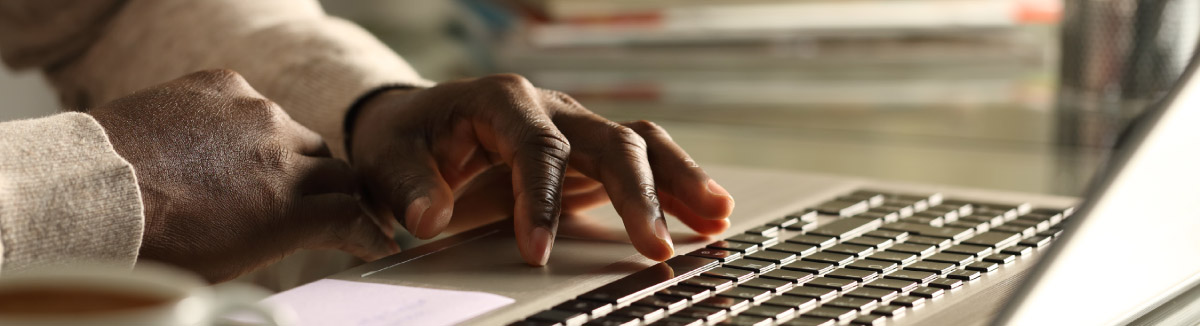 Hands on laptop keyboard