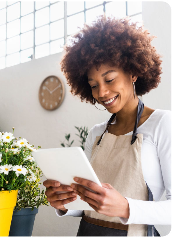 Woman in apron looking at tablet