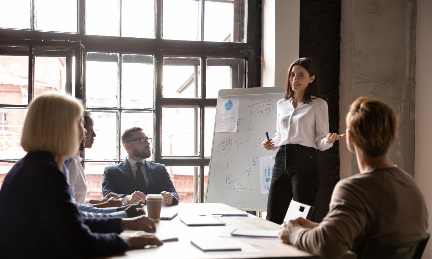 Woman giving a presentation to coworkers