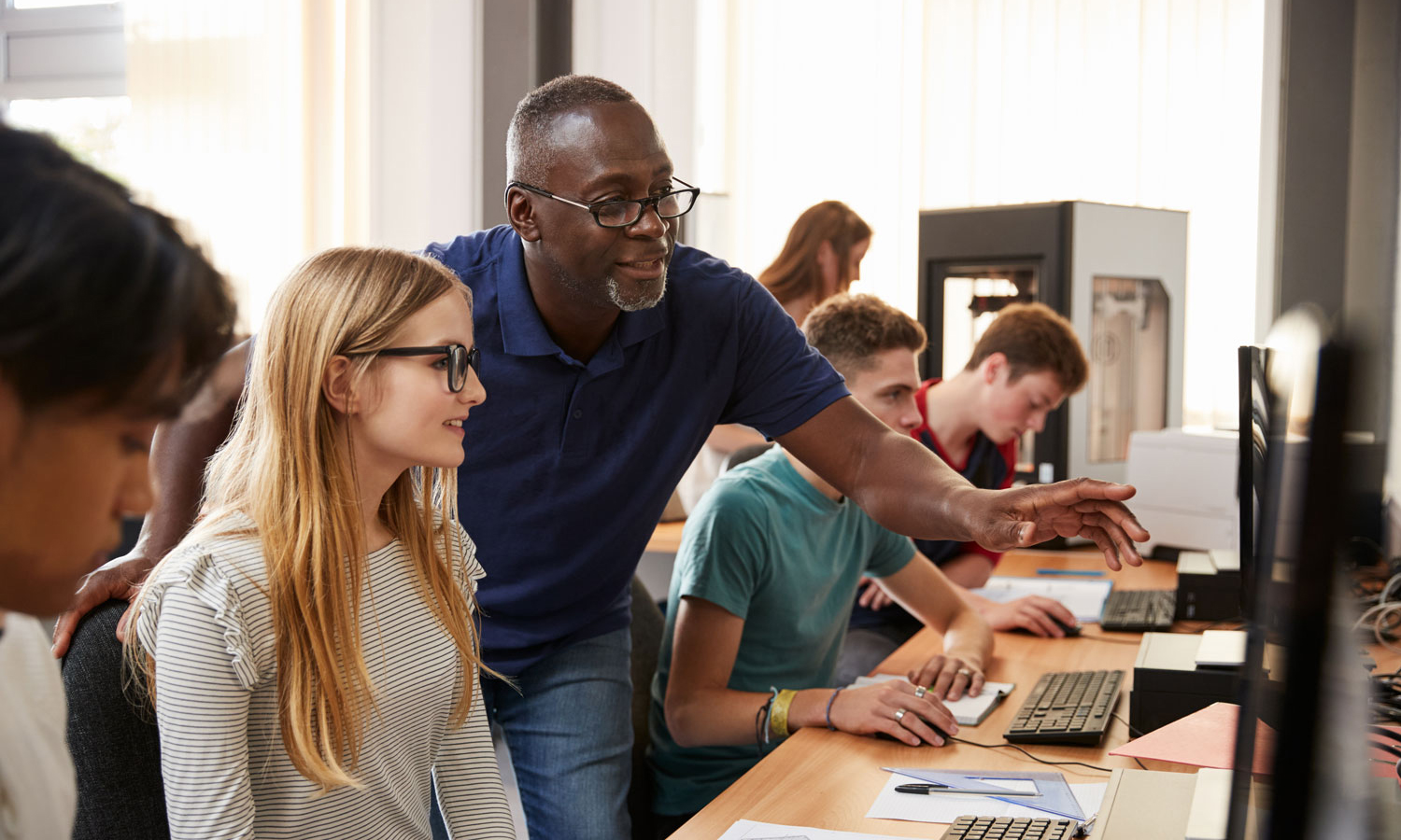 Teacher reviewing work with student
