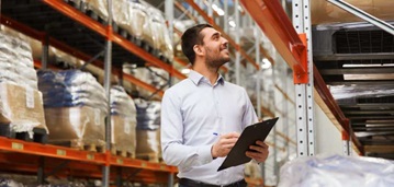 shutterstock_377905639 man in warehouse with clipboard