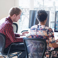 two people sitting at their computers