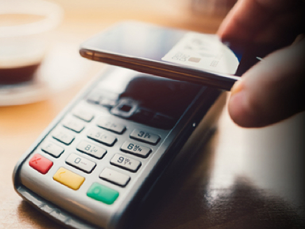 customer using mobile wallet on a POS machine